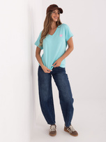 Mint women's blouse with heart-shaped embroidery.