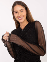 Black draped blouse with appliqués.