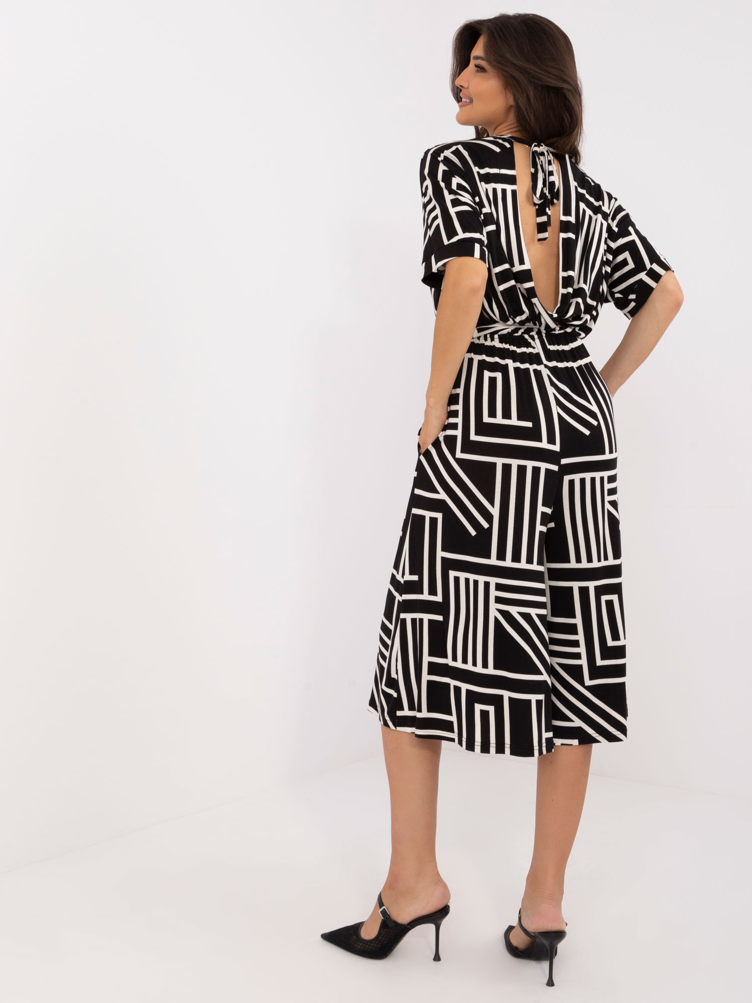 Hurt black patterned jumpsuit with a tie on the back.