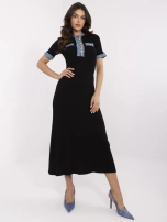 Black knit dress with denim inserts.