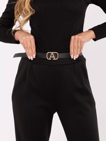 Black sweatpants with decorative buttons.