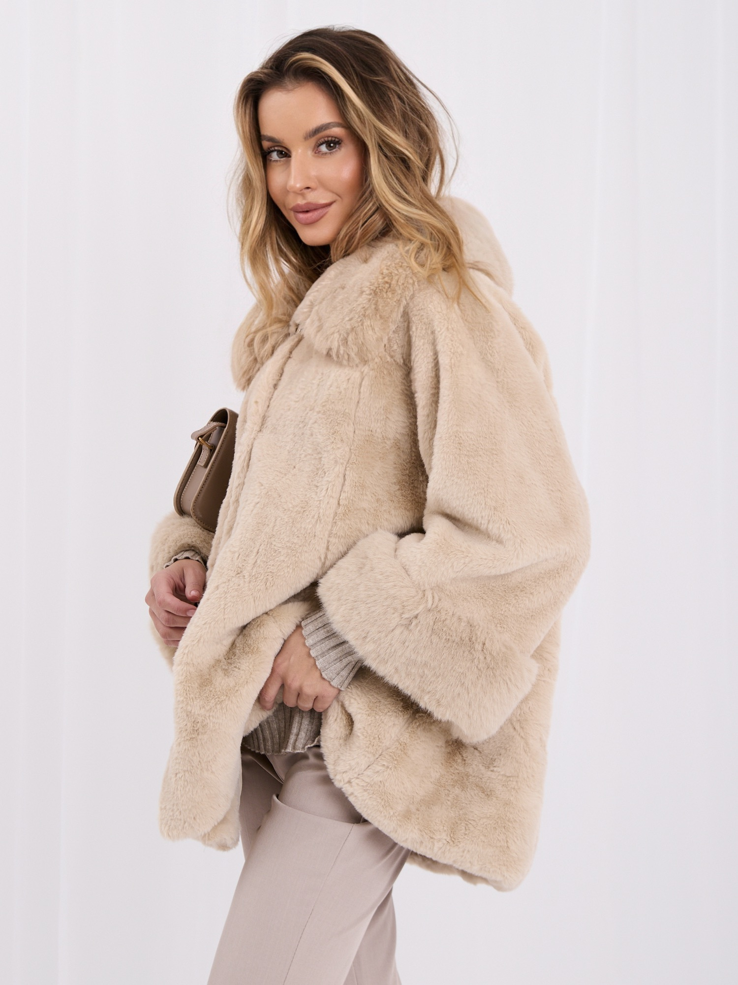Light beige coat made of eco-fur with button closure.