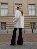 Ecru oversized fur coat with a decorative collar.
