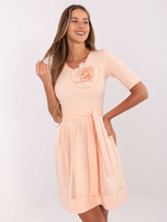 Peach Wholesale cocktail dress with a belt.