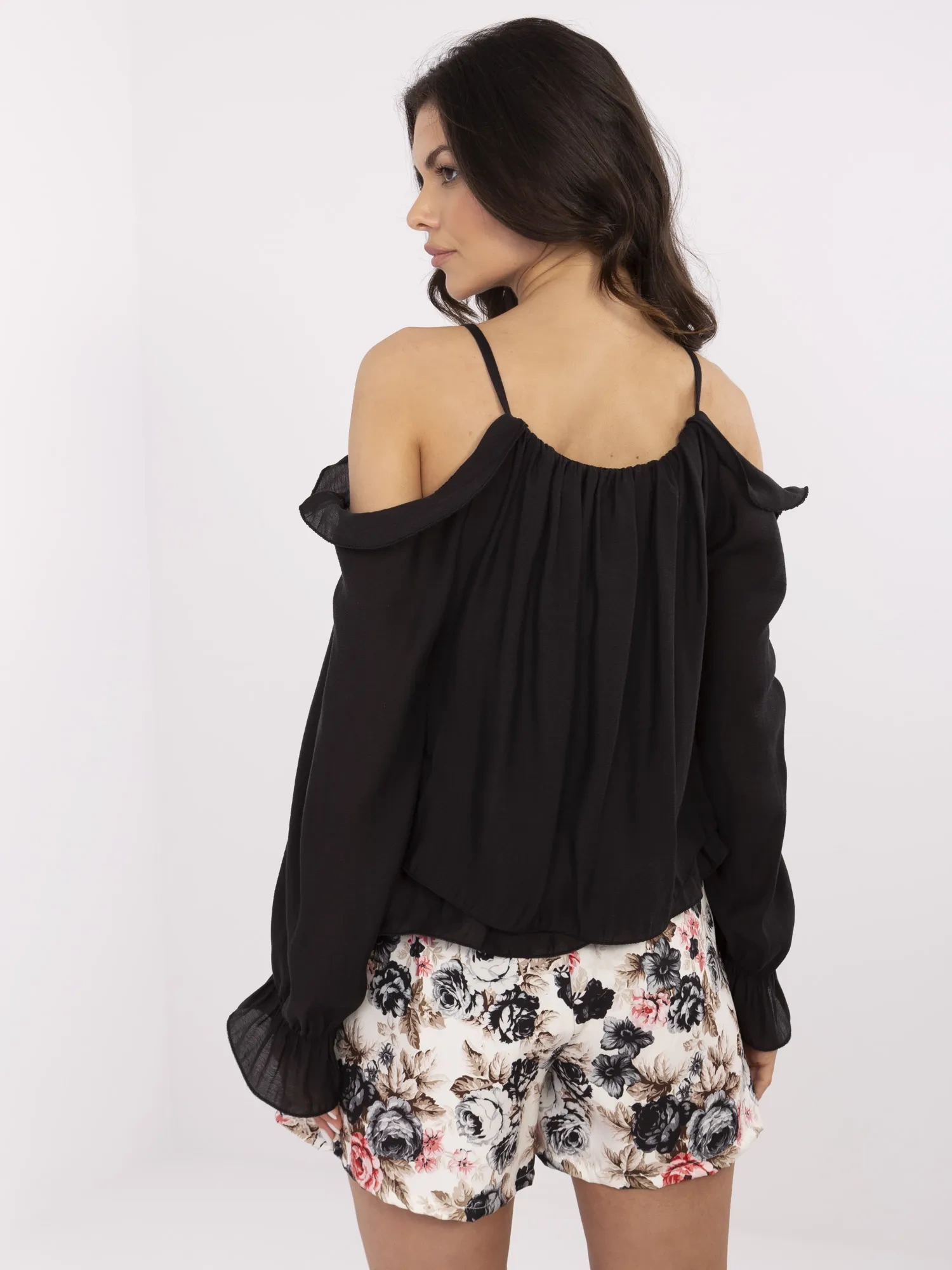 Black blouse with Spanish style and floral brooch.