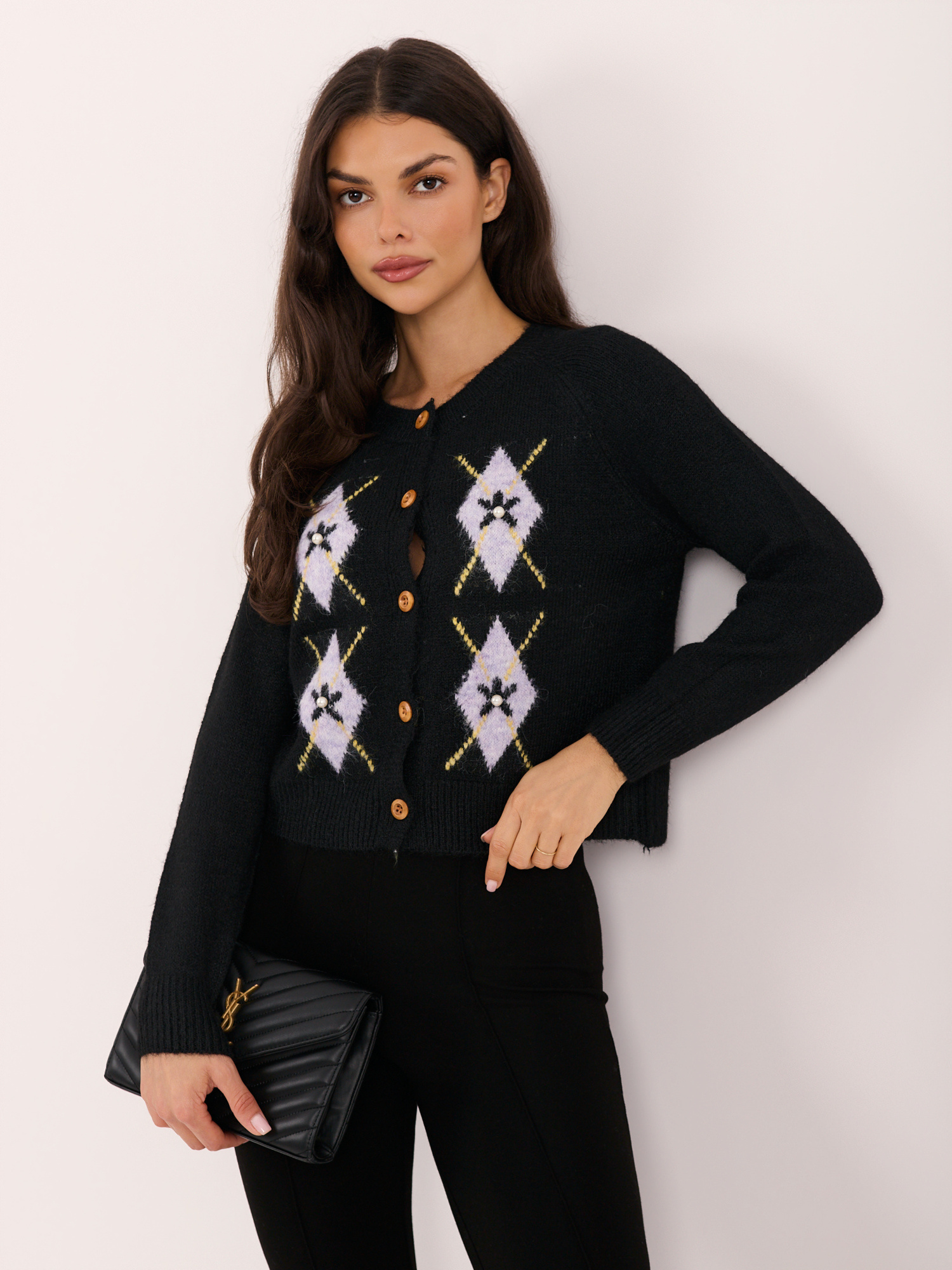 Black zip-up sweater with appliqués.