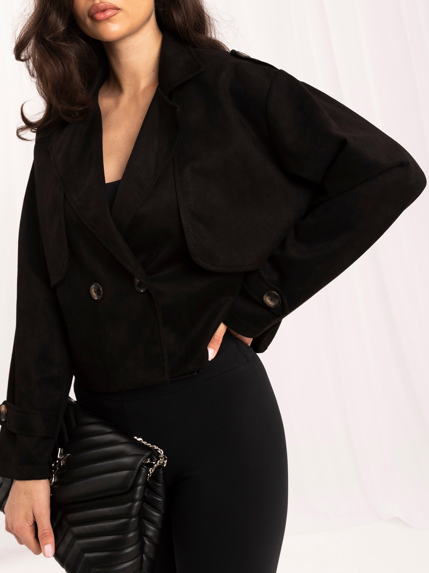 Schwarze Jacke aus Wildlederimitat mit Schulterklappen.