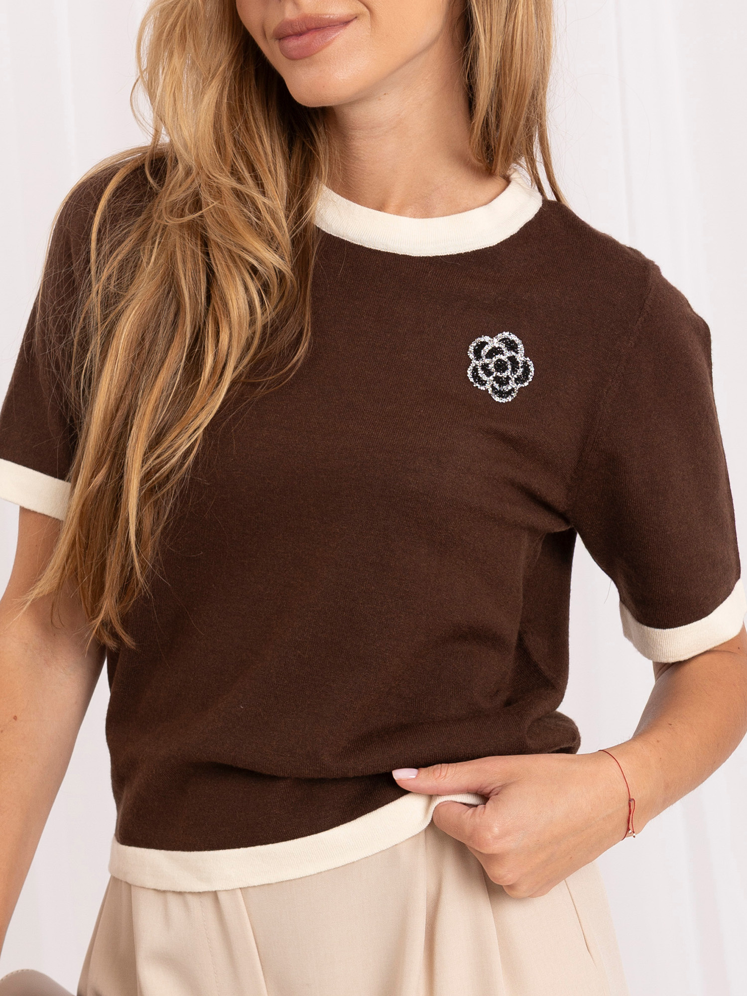 Brown women's sweater with an application.