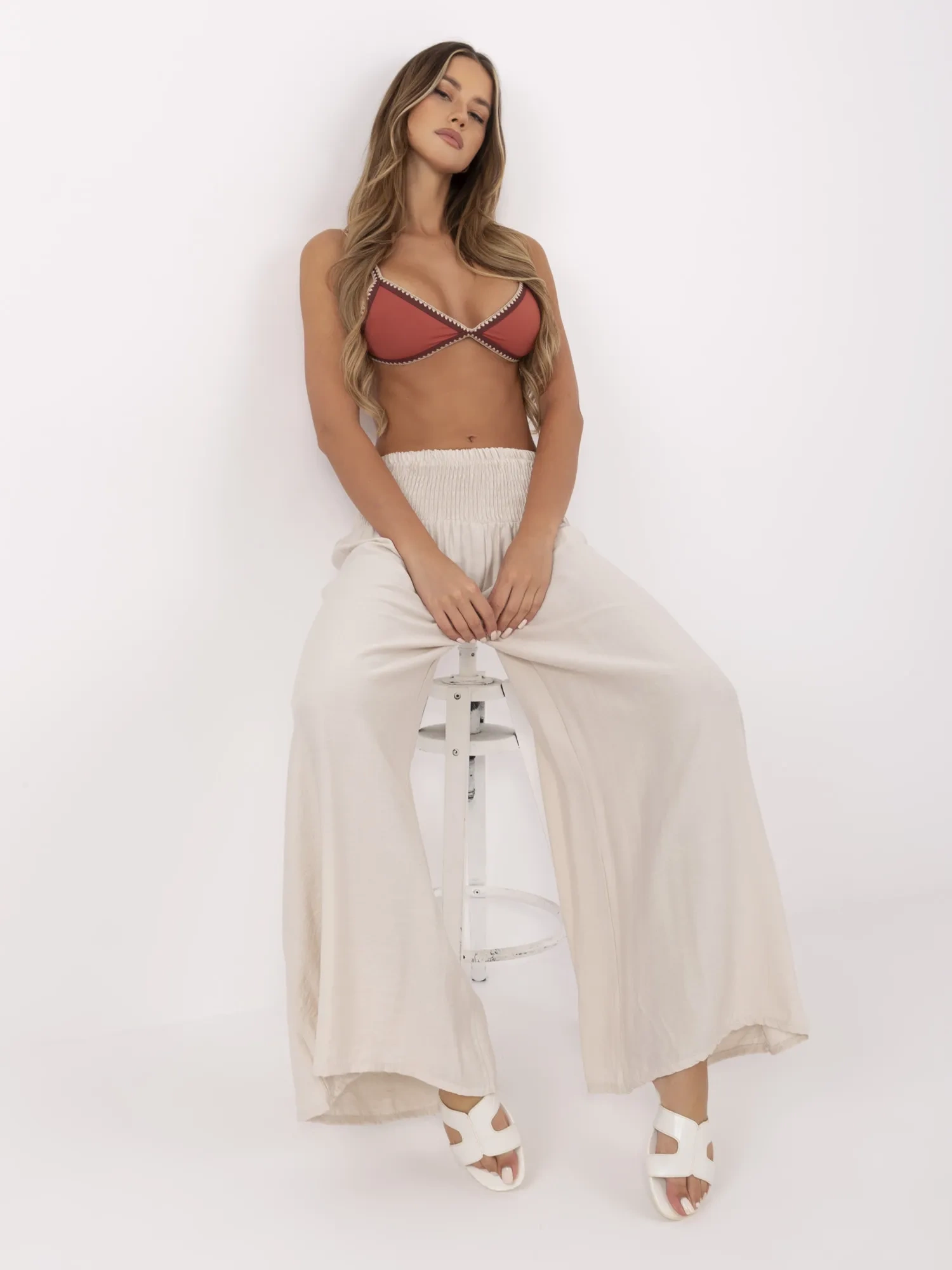 Beige summer pants with a wide elastic band.