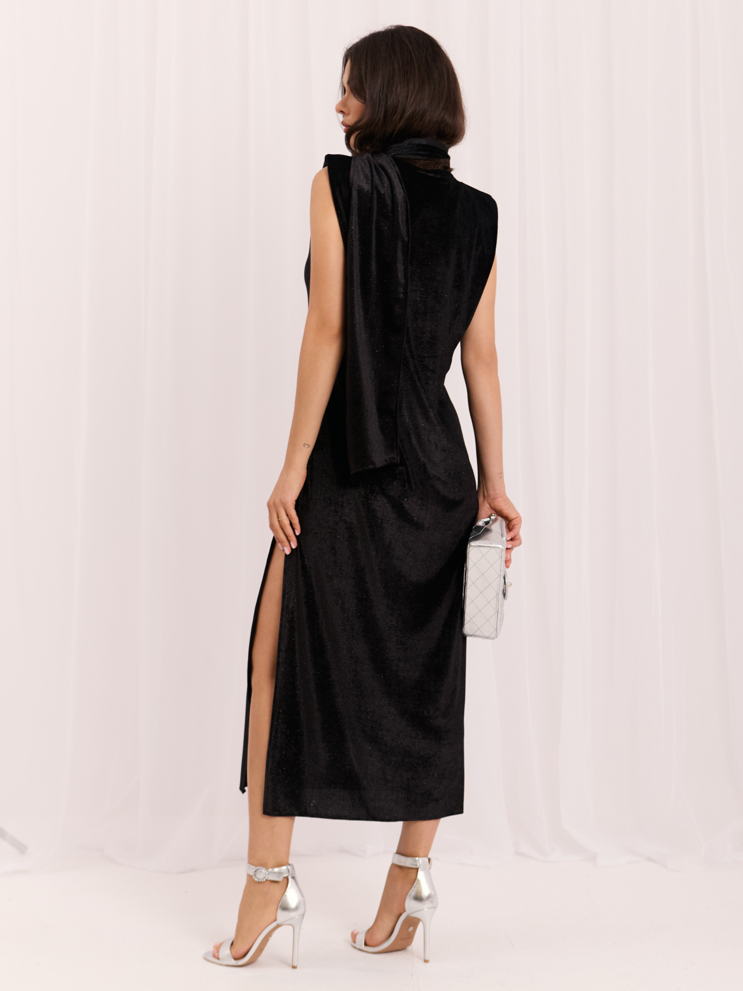 Black velvet dress with shoulder pads.