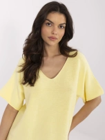 Light yellow reversible sweater with a V-neck.