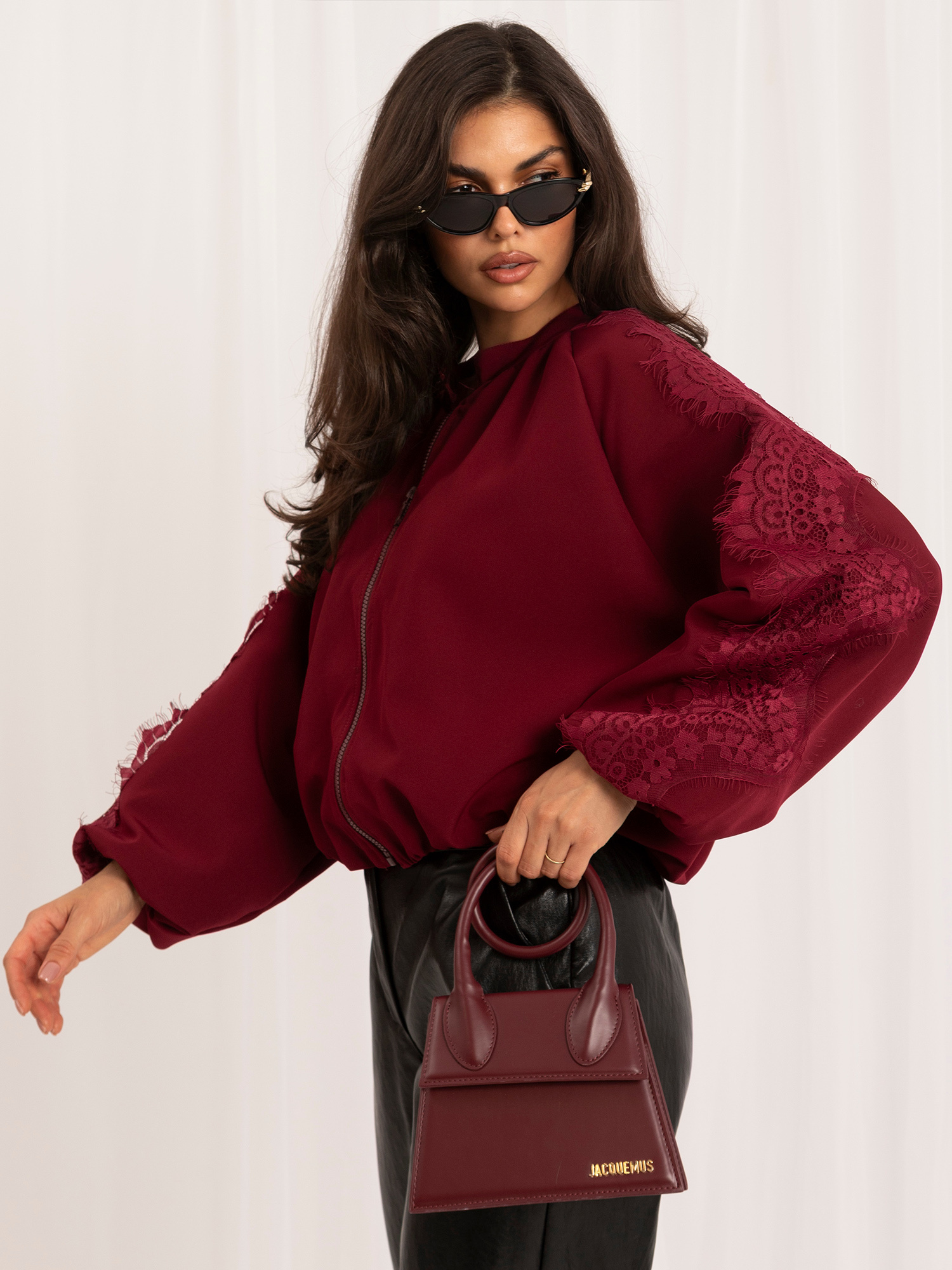 Burgundy bomber jacket with puff sleeves.