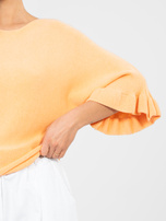 Pastelowy pomarańczowy sweter z jednolitym kolorze