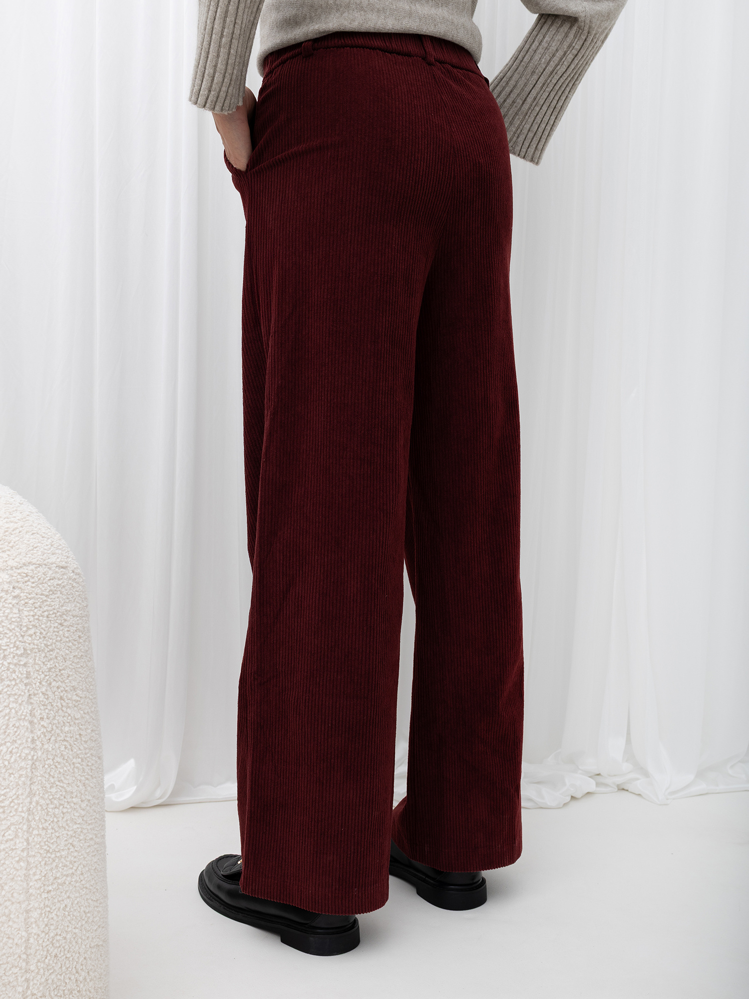 Burgundy corduroy wide leg pants with pockets.