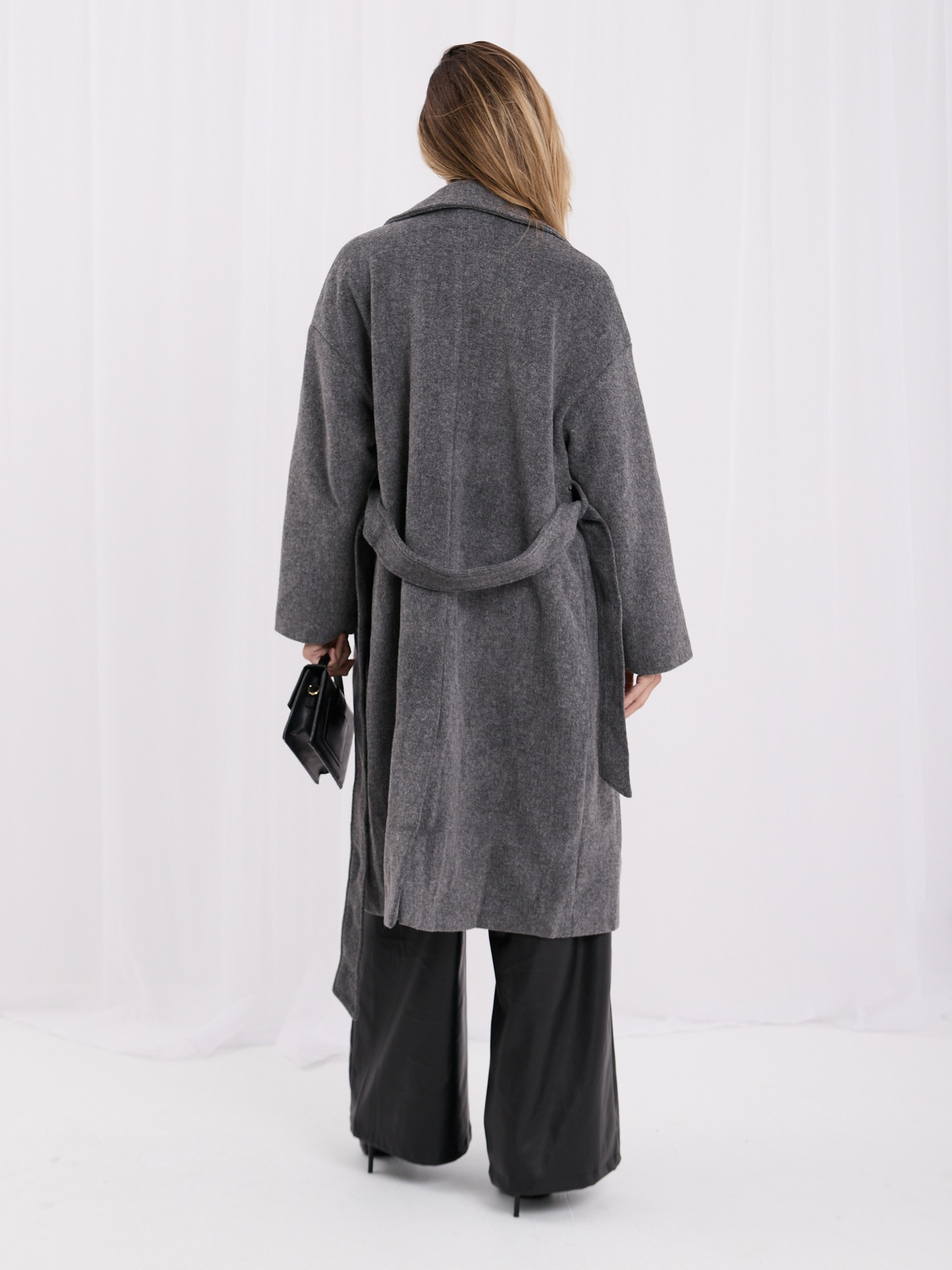 Dark gray oversized transitional coat with a belt.