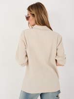 Beige button-up muslin shirt.