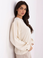 Light beige sweatshirt with puff sleeves.