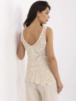 Beige lace blouse with straps.