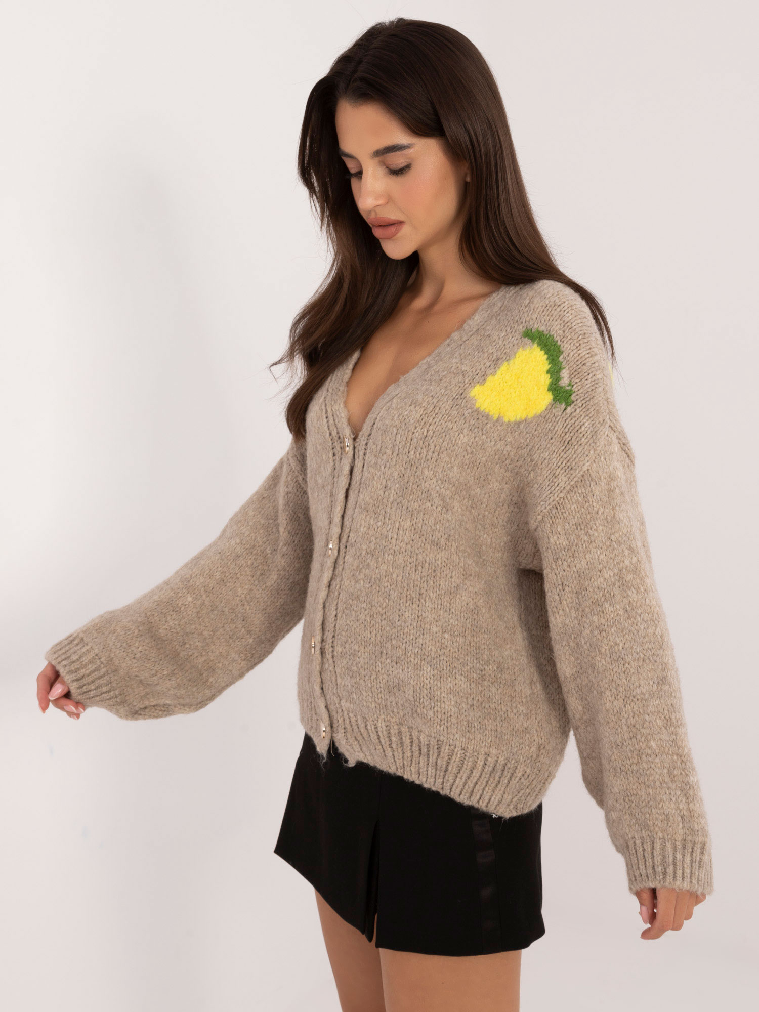 Beige zip-up sweater with a print on the back.