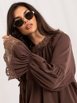 Dark beige blouse with a bow on the back.