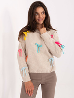 Jasnobeżowy sweter z kolorowymi kokardkami