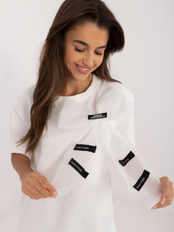 Wholesale Ecru blouse with a bow and inscriptions.