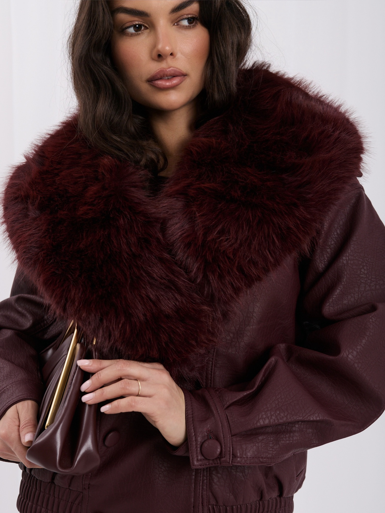 Burgundy faux leather jacket with detachable fur.