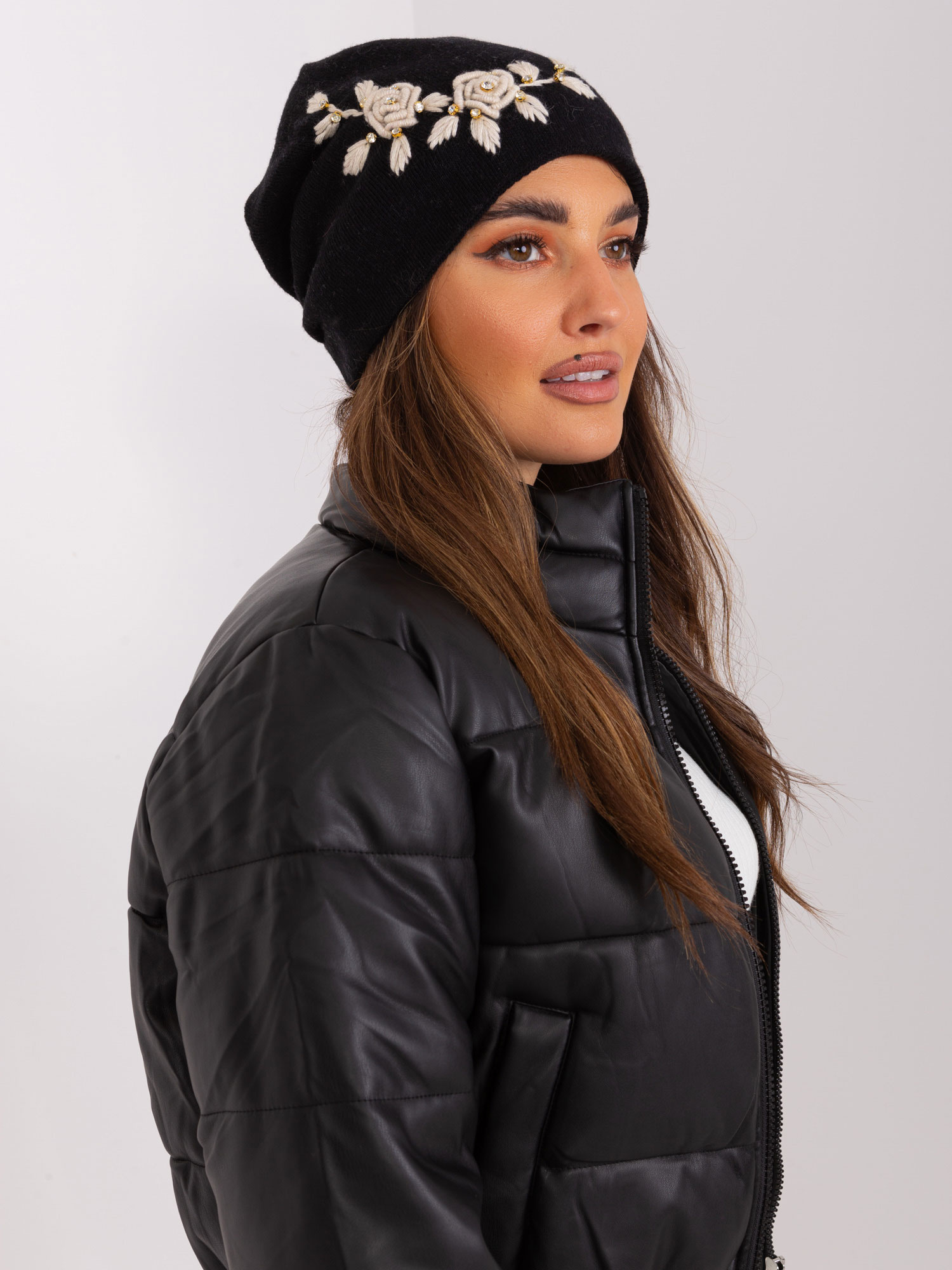 Black and beige knitted hat with appliqué and rhinestones