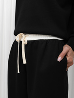 Black tracksuit set with wide pants.