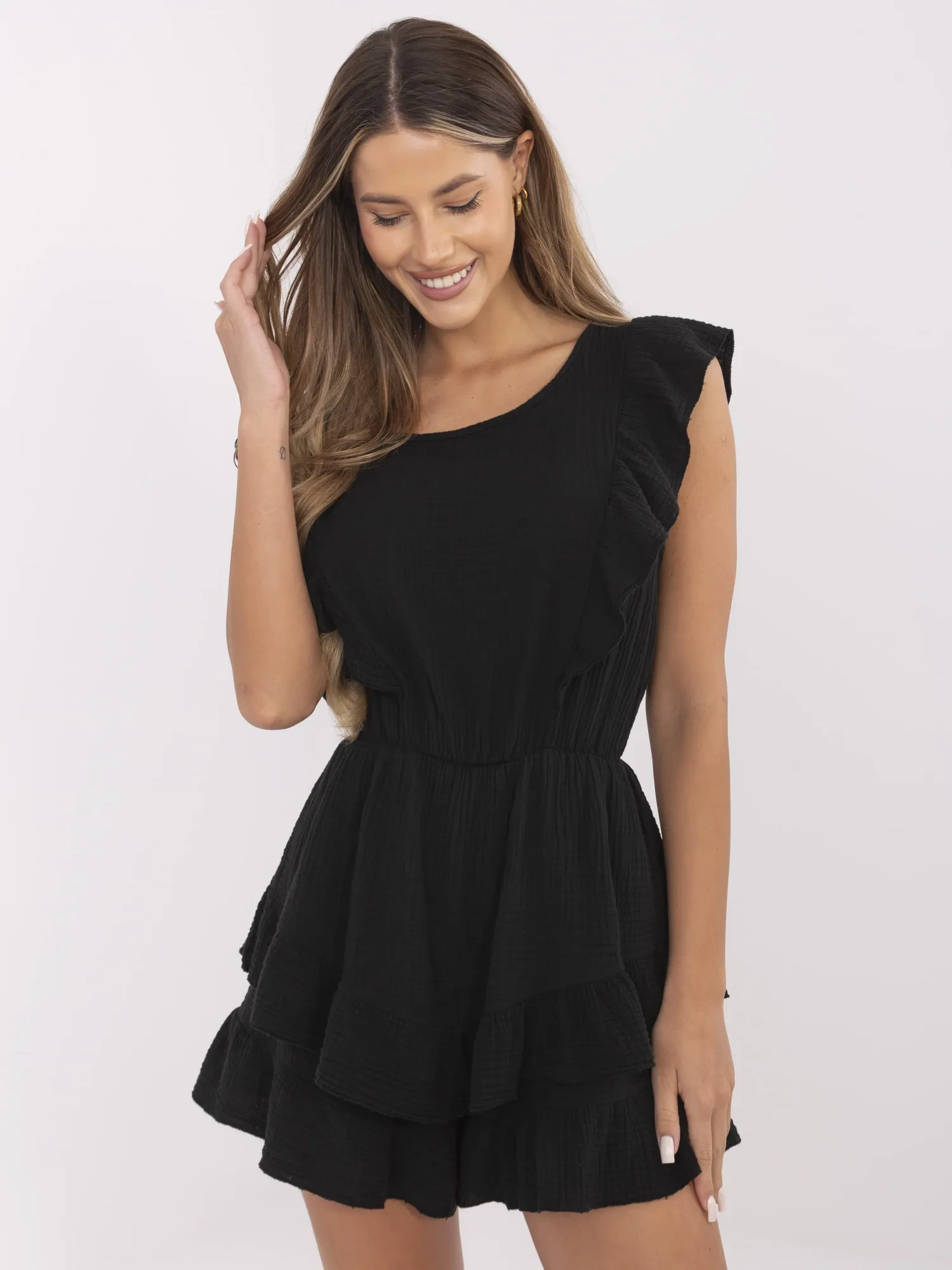 Black muslin jumpsuit with ruffles.