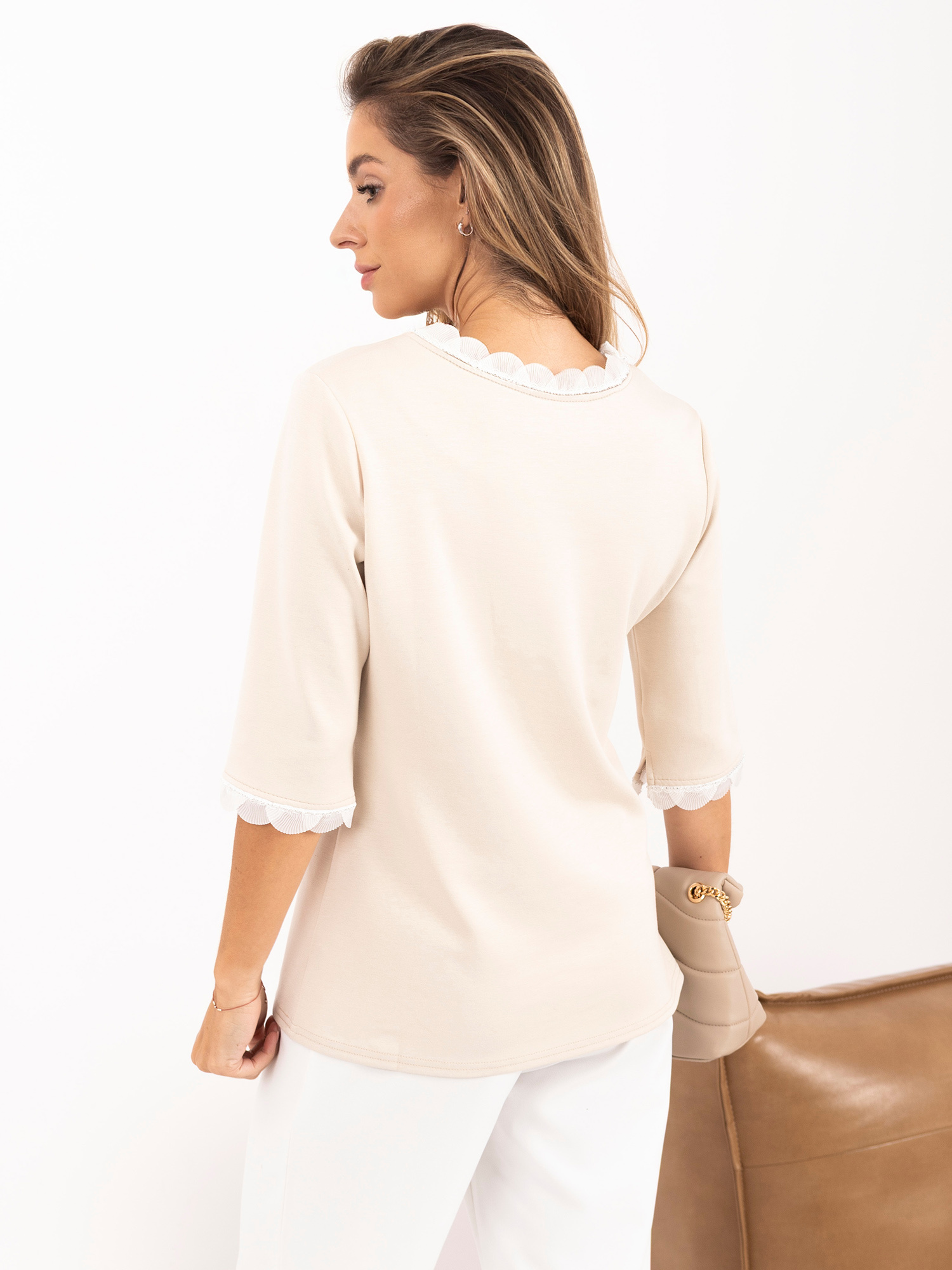 Light beige blouse with decorative finishing.