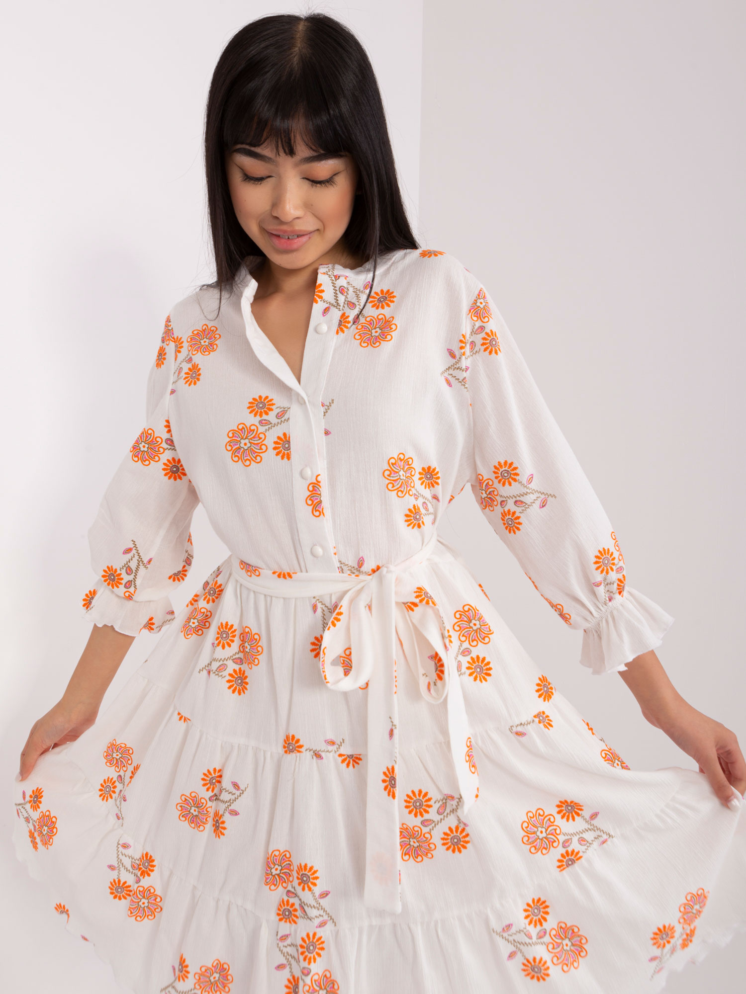 Hurt White-orange patterned dress with a frill.