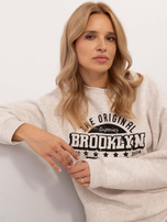 Hurtownia Jasnobeżowa melanżowa bluza oversize z nadrukiem