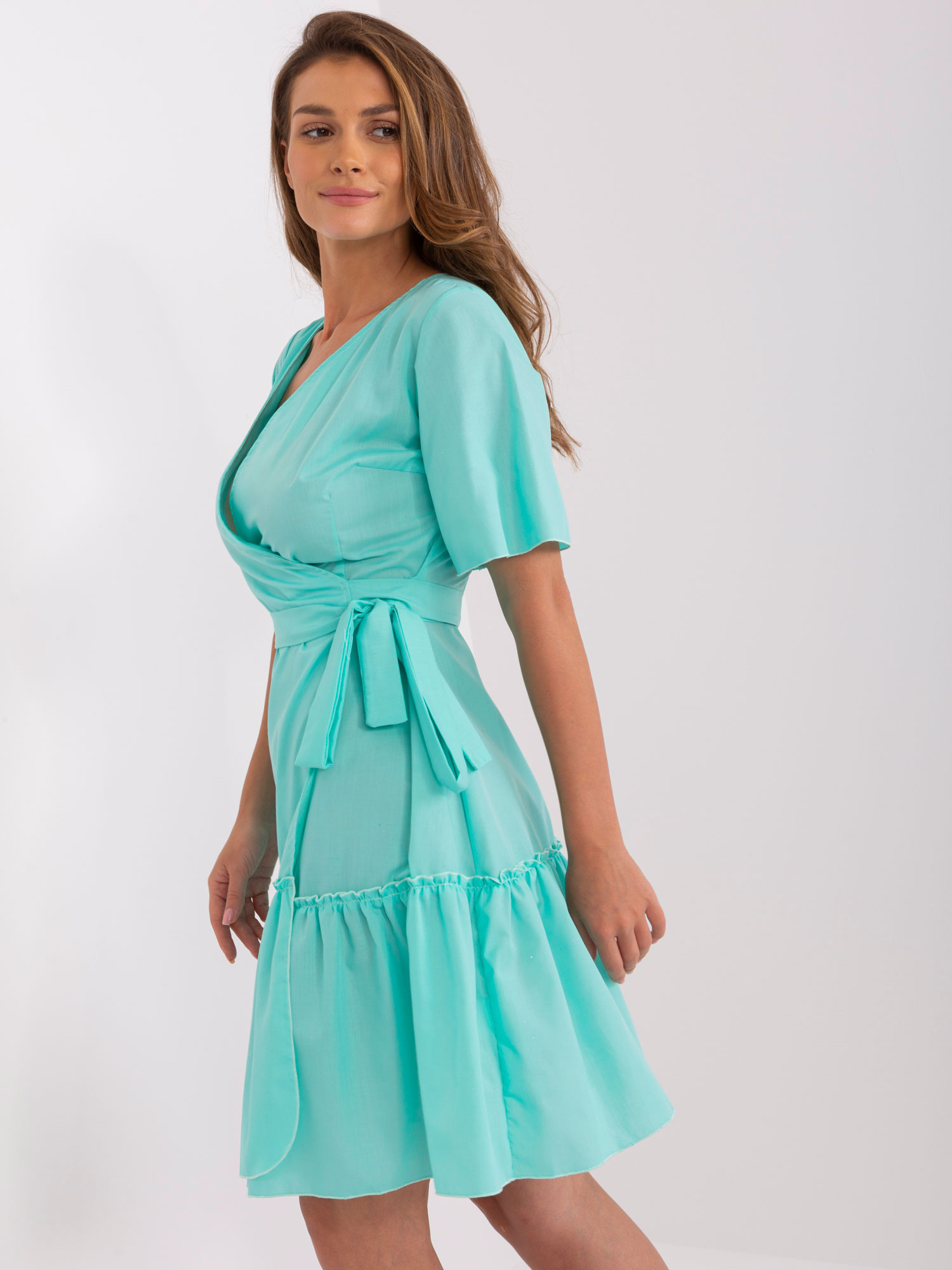 Mint green envelope dress with ruffle.