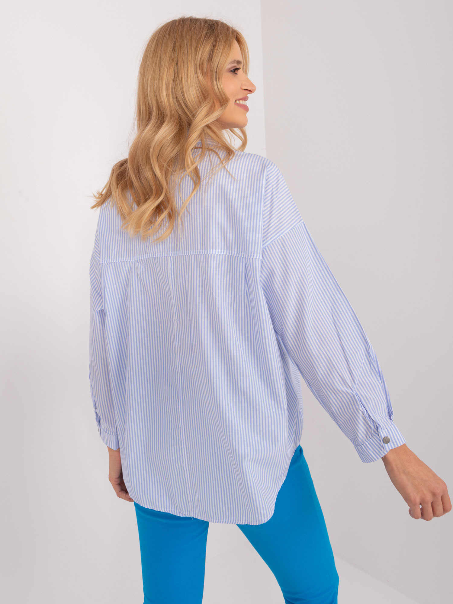 Light blue and white oversized women's shirt with a collar.