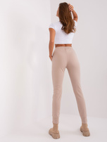 Beige women's sweatpants with inscriptions.