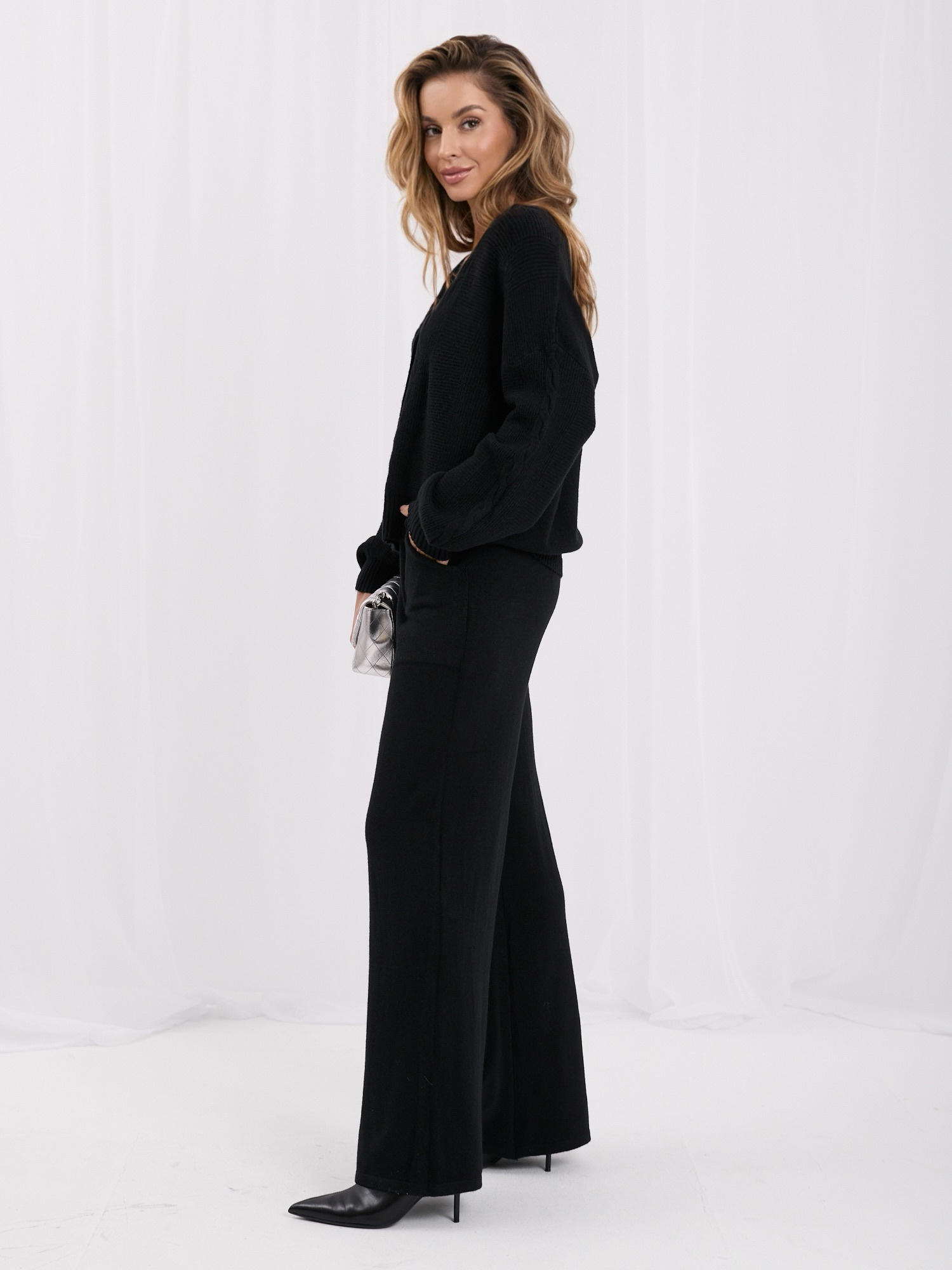 Black sweater set with wide pants.