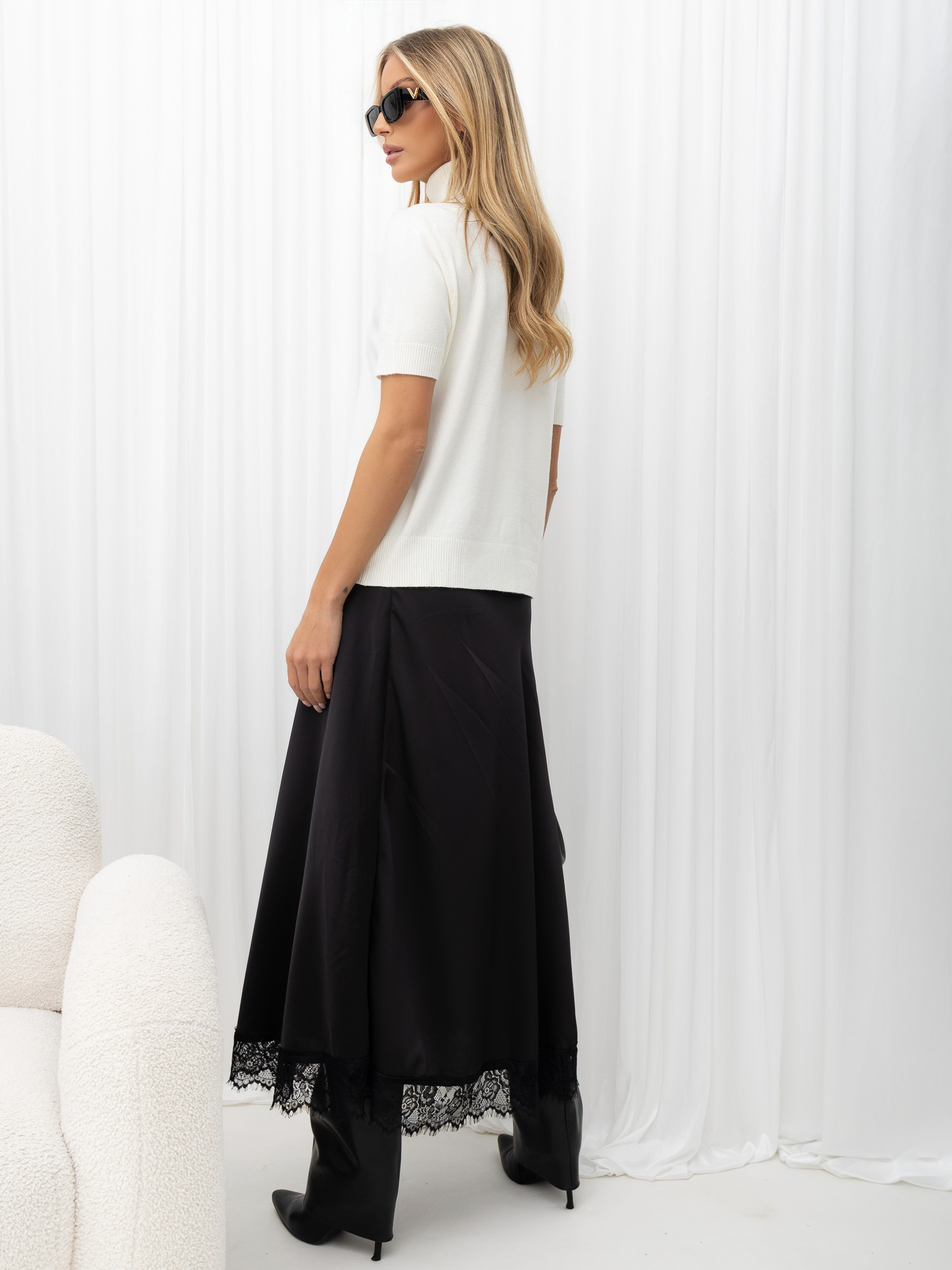 Black skirt with a satin effect and a lace bottom.
