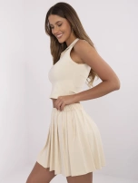 Light beige sports set with a pleated skirt.
