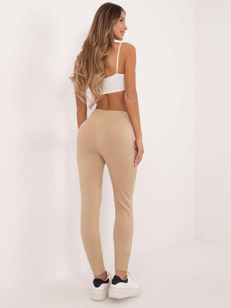 Hurt Beżowe damskie spodnie dresowe z kieszeniami