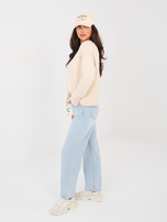 Light blue balloon jeans with a belt.