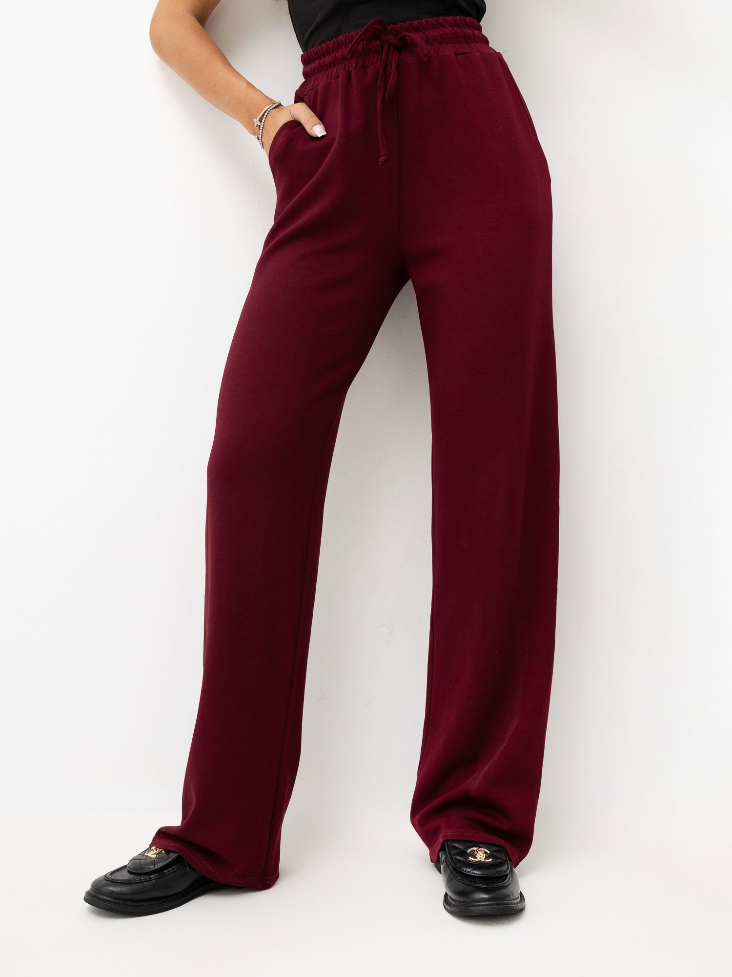 Burgundy sweatpants with wide legs.