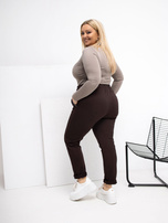 Plus size chocolate pants with decorative inserts.