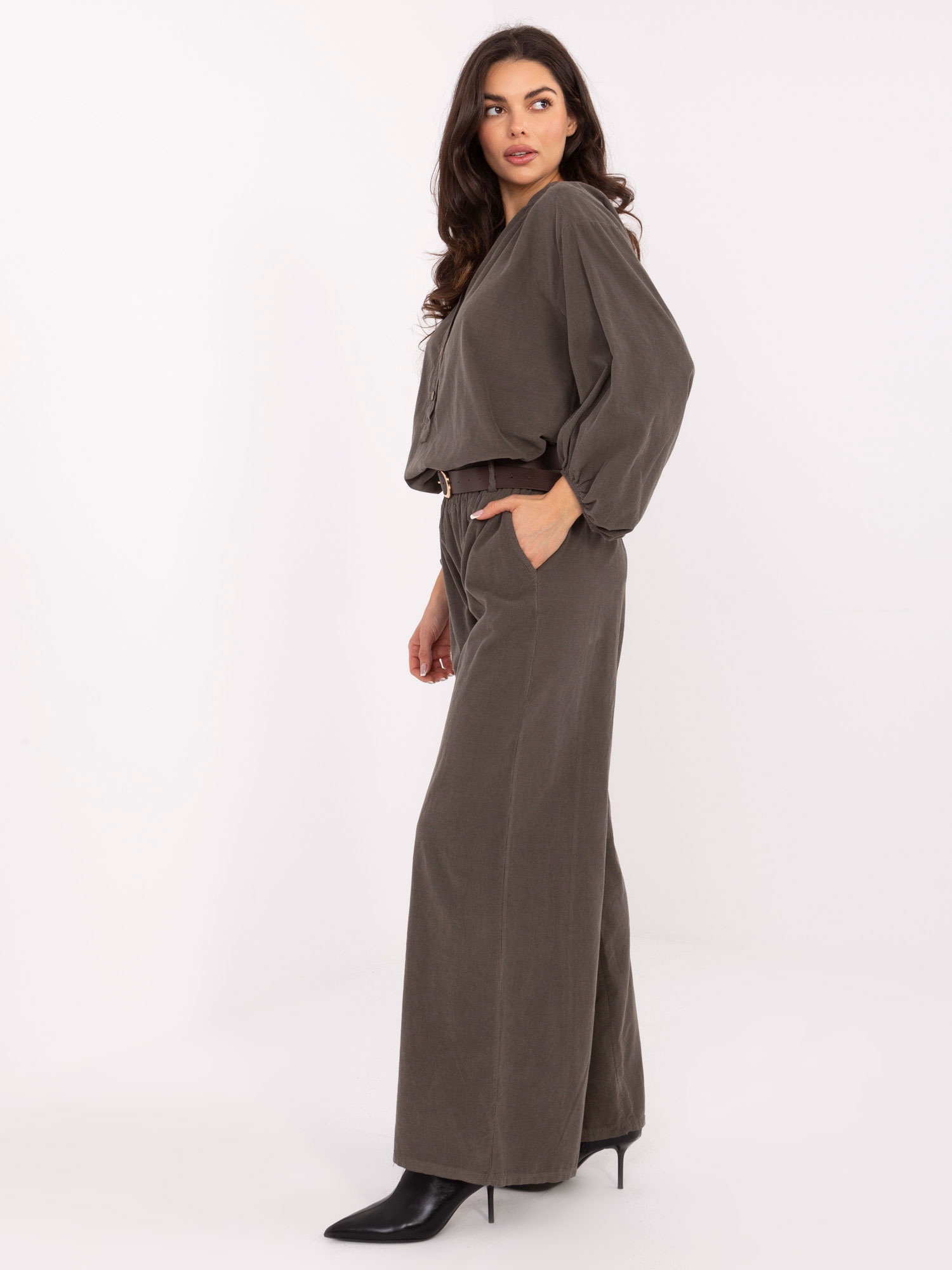Khaki corduroy pants with a belt.