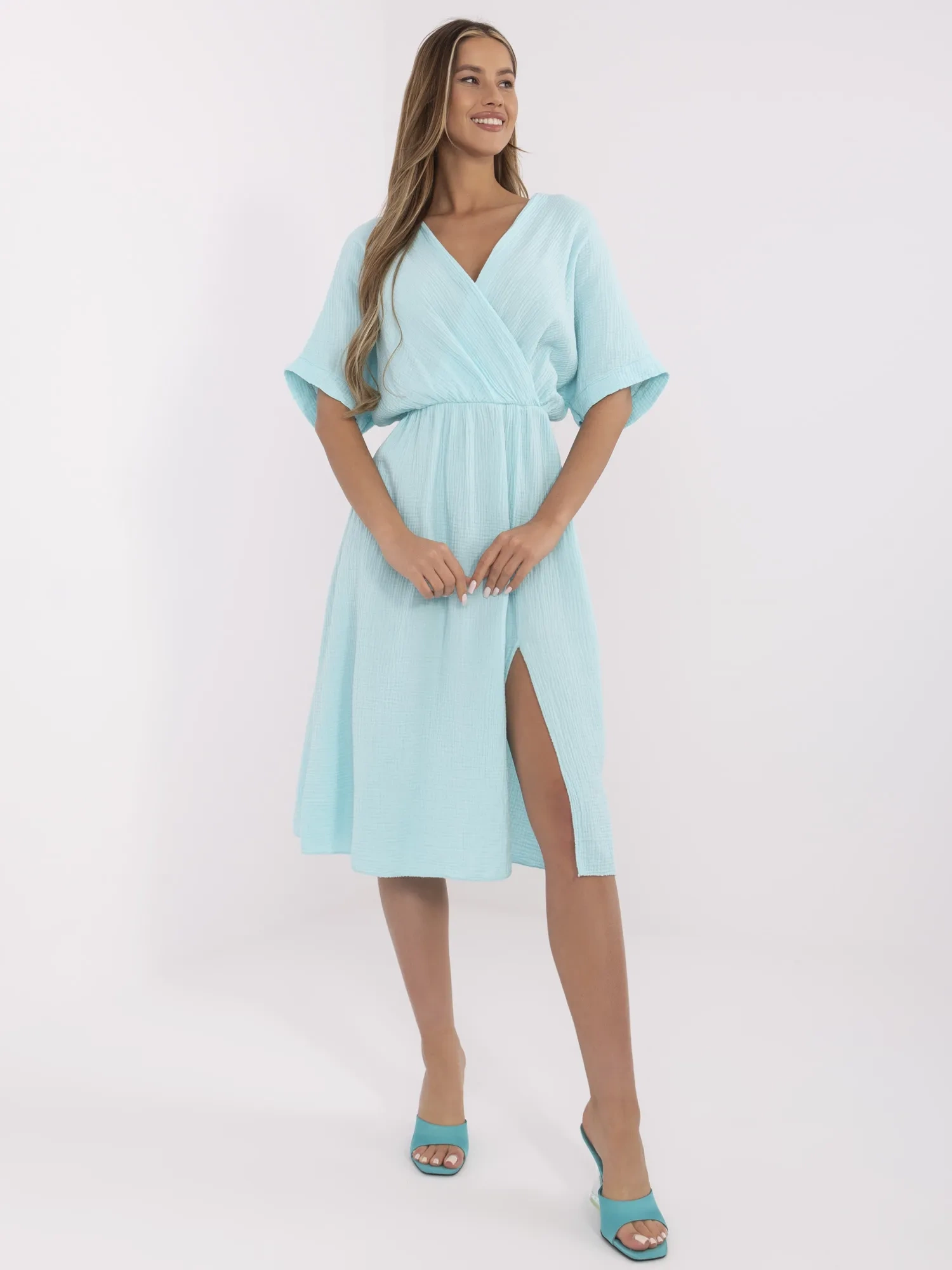 Mint muslin dress with a wrap neckline.