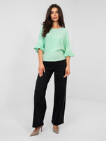 Pastelowy miętowy sweter z rozkloszowanym rękawem