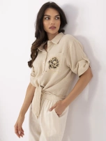 Beige muslin shirt with a tie.