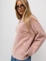 Light pink alpaca jacket with zippers on the sleeves.