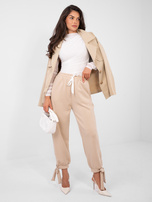 Beżowe dresowe spodnie ze ściągaczami 