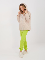 Beige quilted jacket with a zipper.